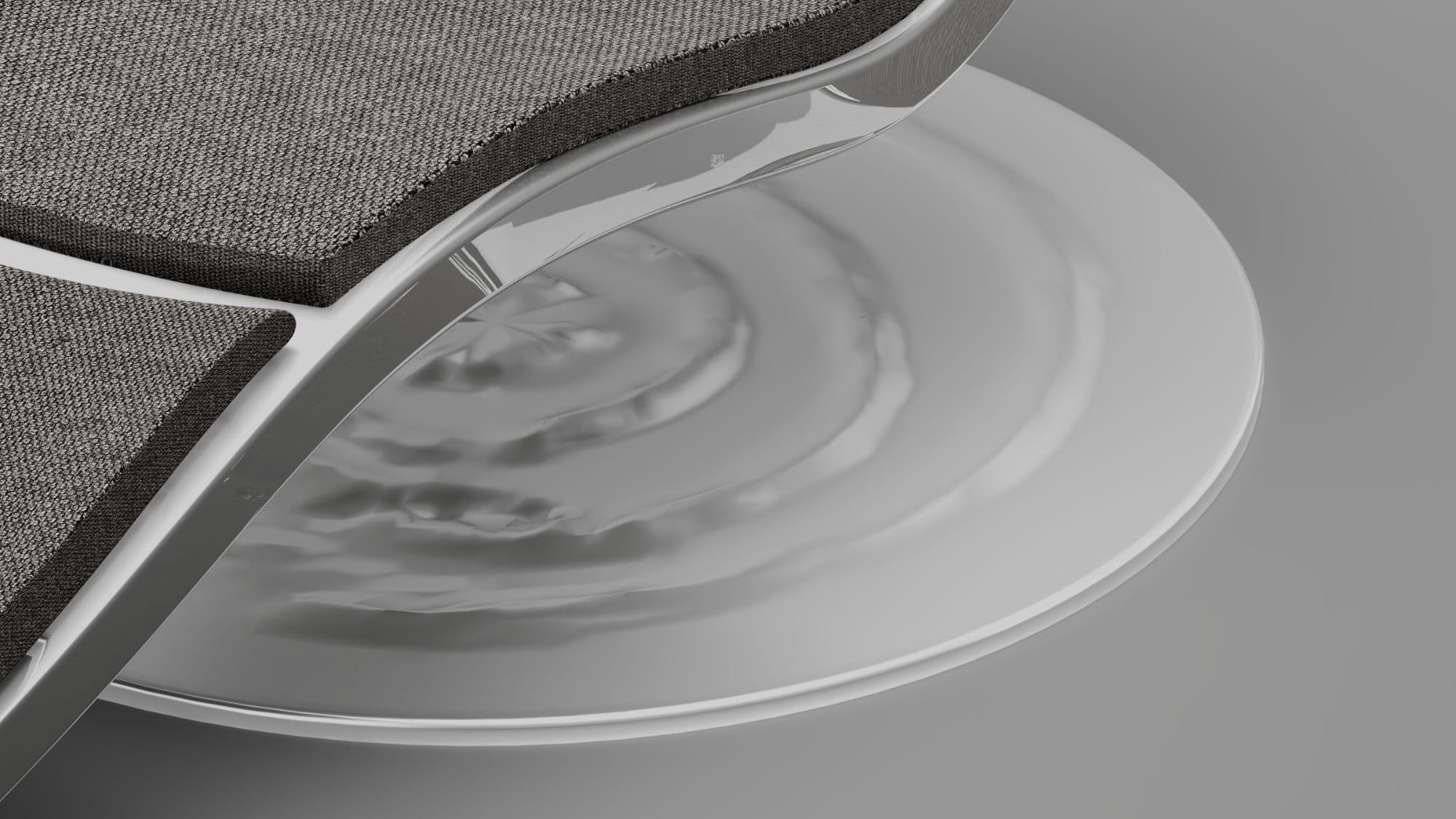 Close-up of the acrylic body curving over the steel base with its water-drop ripples
